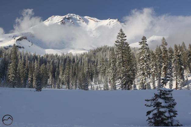 Mount Shasta, blanketed in fresh snow, rises above Bunny Flat